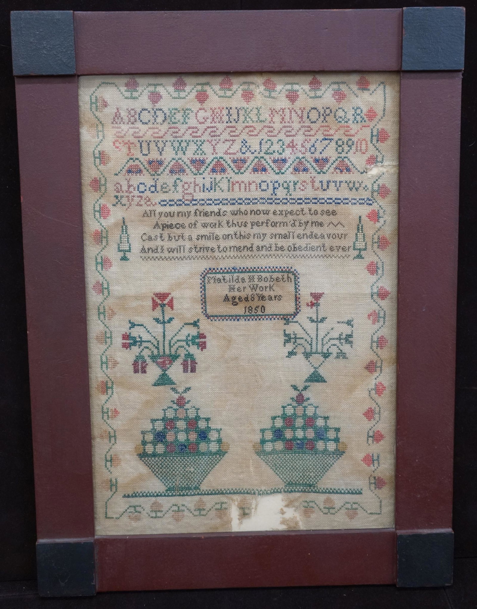 SAMPLER: Framed; embroidered cloth; circa 1850; some fabric loss; visible staining; fading and darkening; H- 21"; F-G