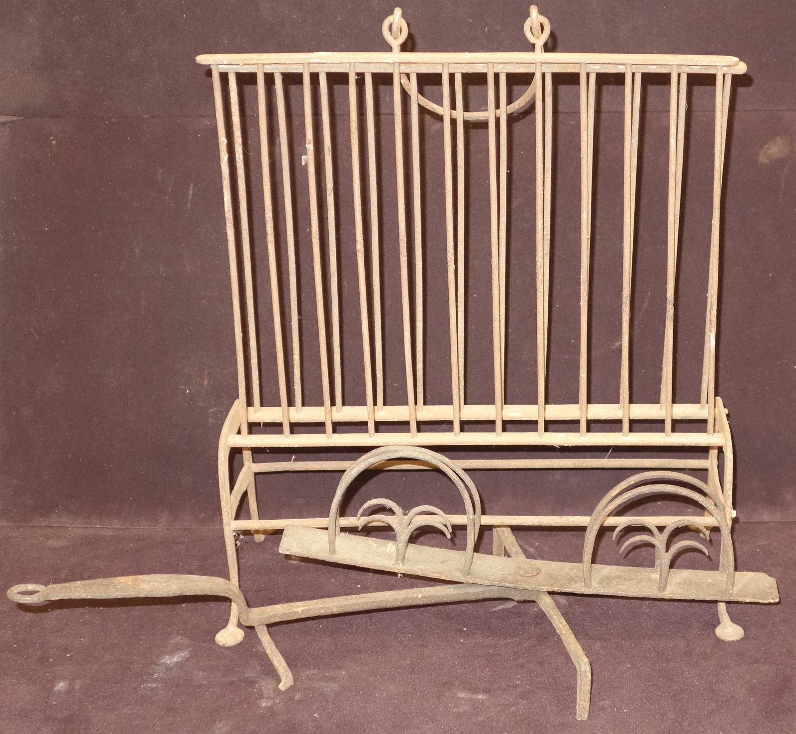 ANTIQUE HEARTH TOOLS (2): Metal and wrought iron; (1) upright handled, free standing, with movable armature; (1) bread warmer with movable platform; normal wear; broken weld on bread warmer; tallest H-21", G-VG