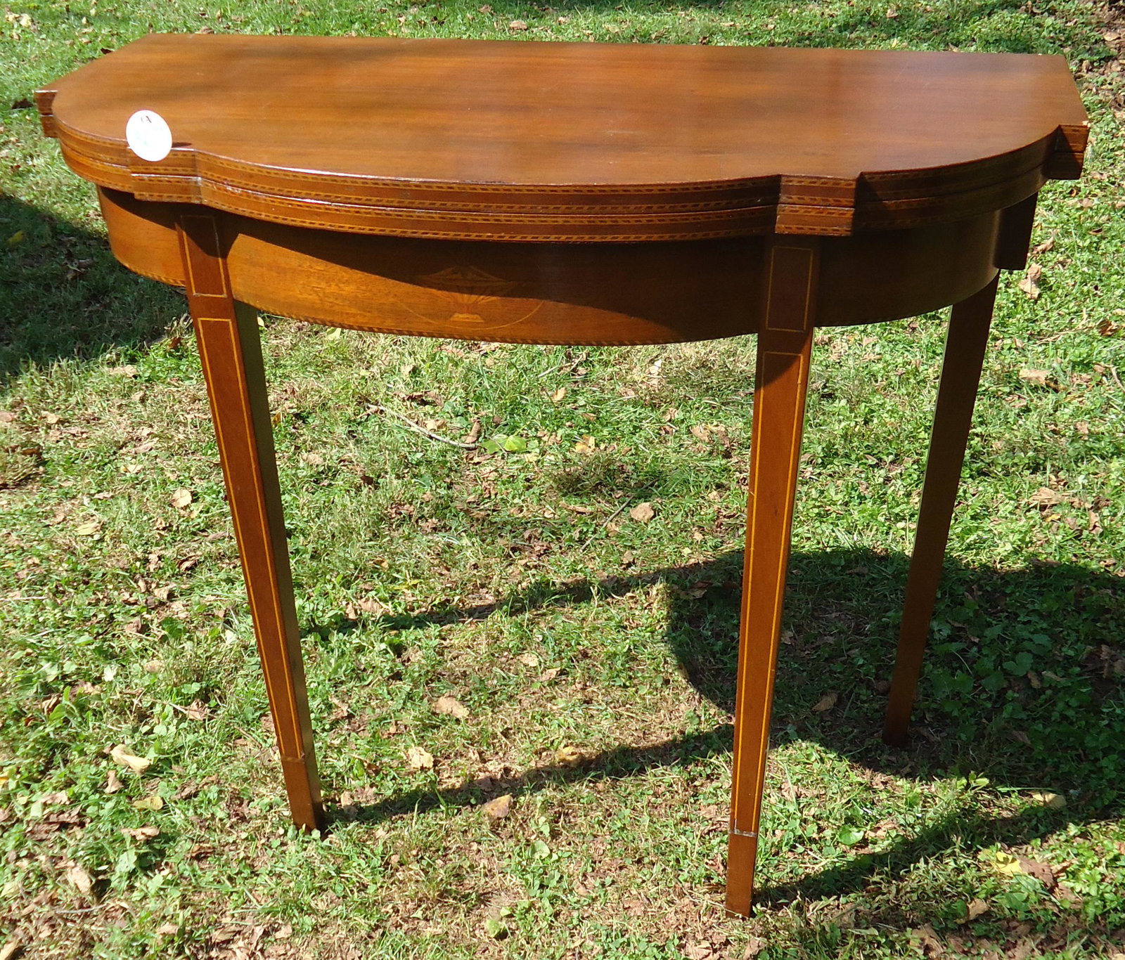 HEPPLEWHITE STYLE CARD TABLE: Mahogany; line and band inlay; small chip off top edge; H-31", L-36", G-G+