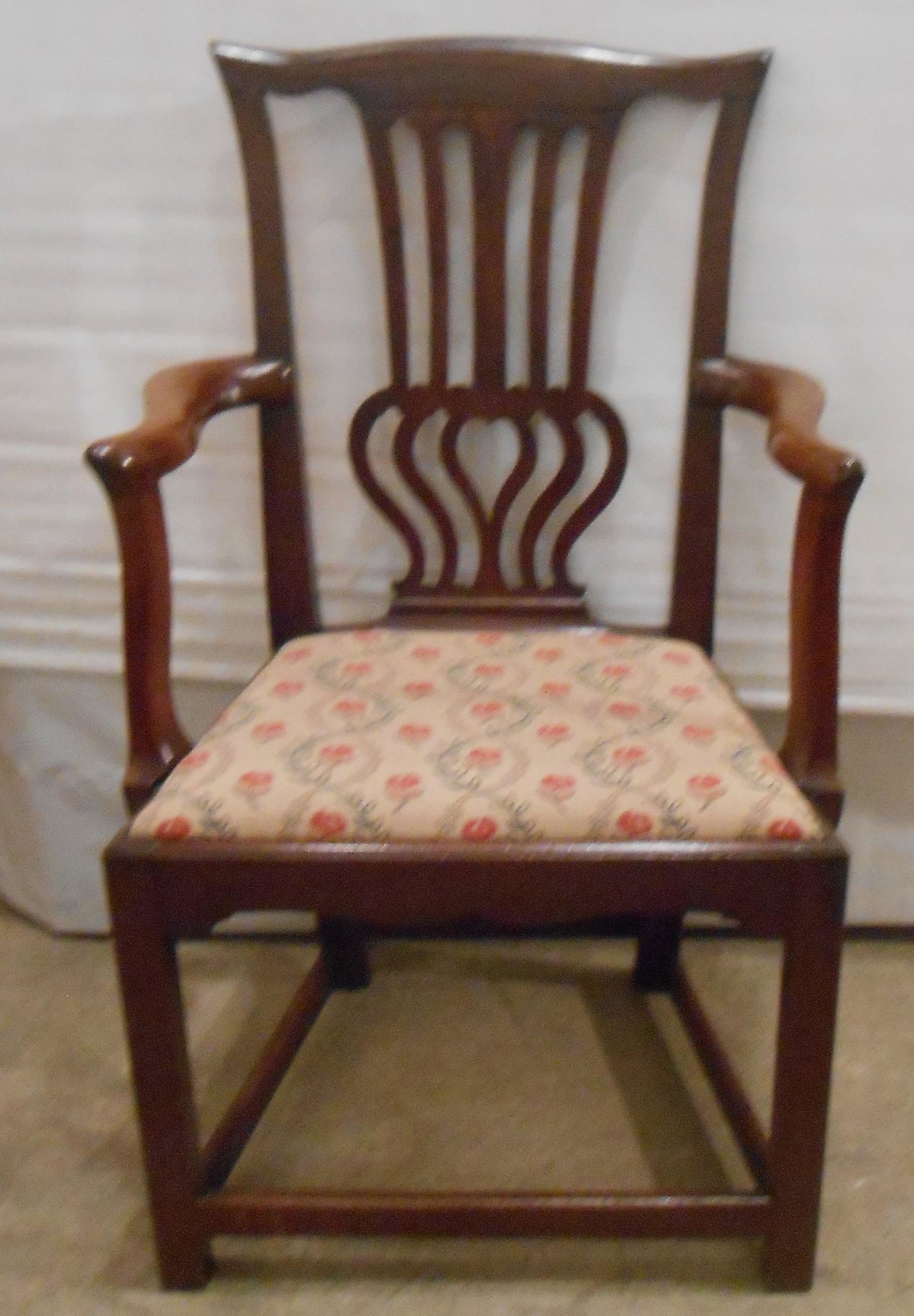 ANTIQUE CHIPPENDALE ARM CHAIR: Mahogany; pierced splat back; slip seat; stretcher base; old refinish; some minor splits; normal wear; H-42", W-24", G-VG