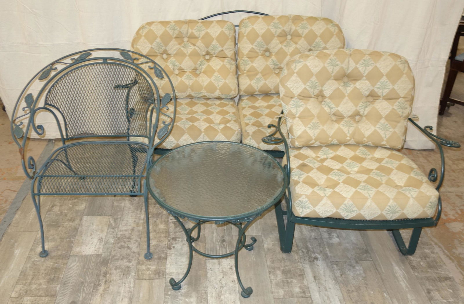 WROUGHT IRON OUTDOOR FURNITURE (6) PCS.: Painted; (1) settee, (2) bounce chairs, (2) arm chairs, (1) end table with tempered glass top; some cushions included; minor stains; minor paint loss and rust; settee L-58", G-VG