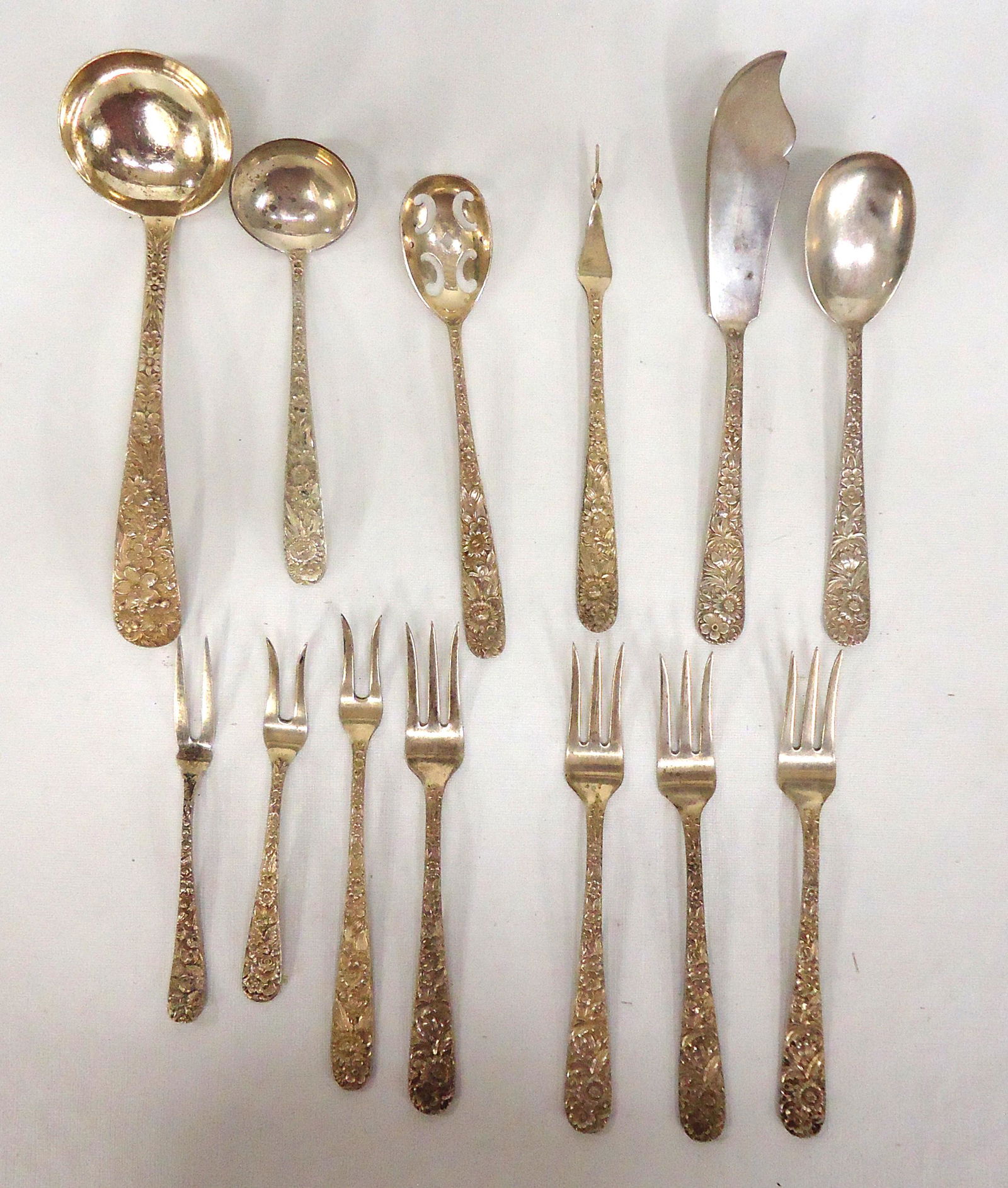 STERLING SERVING UTENSILS S. KIRK & SONS (13): Repousse no monogram. (4) Cocktail forks 6" L .85 T.O. (1) Lemon fork 6"L .72 T.O. (2) Olive forks 5"L .43 T.O. (1) Nut pick 6"L .69 T.O. (1) small ladle 5" L 1 T.O. (1) Gravy ladle 6.5 "L 2.22 T.O. (