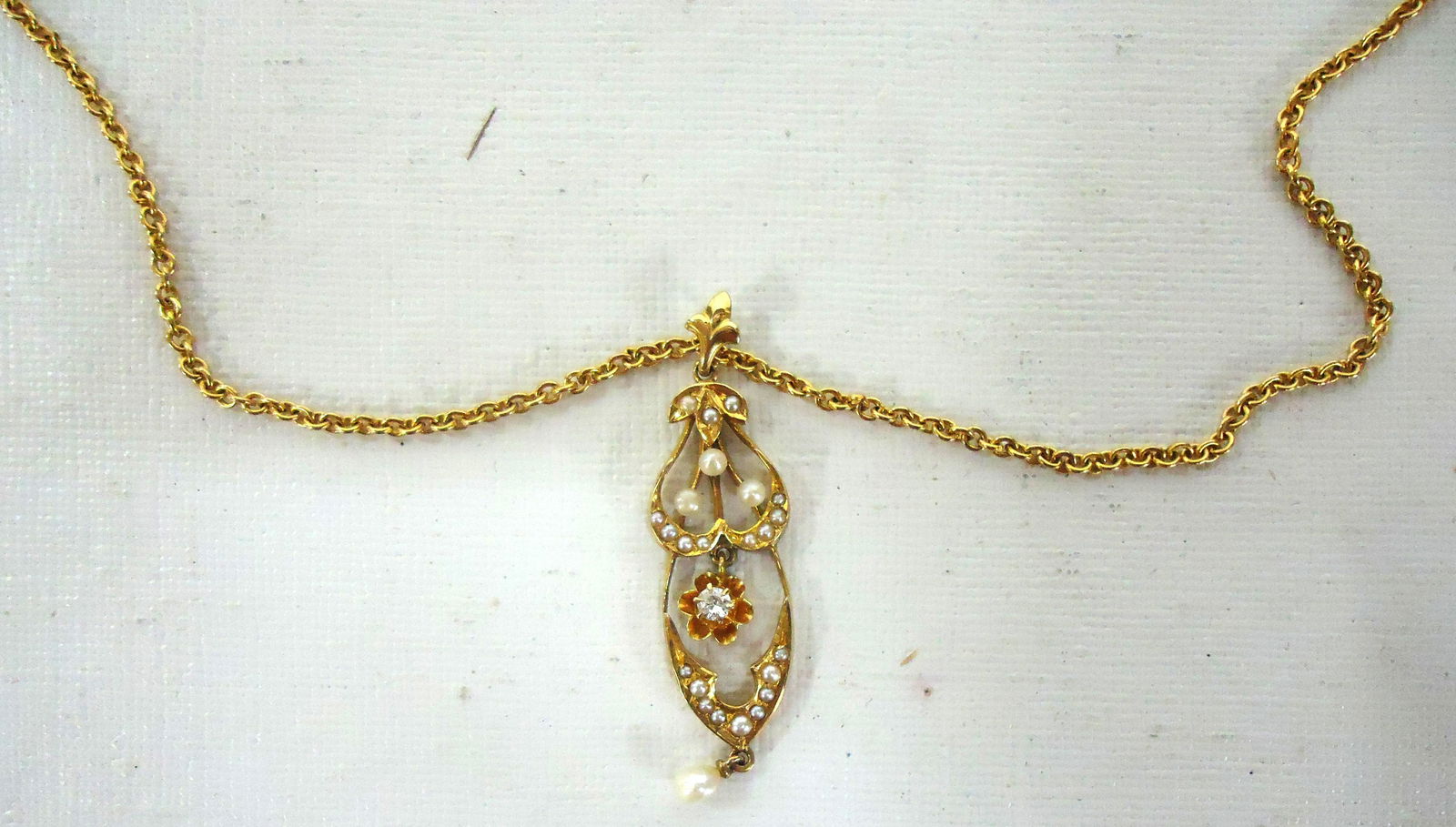 ART NOUVEAU NECKLACE AND DROP: (1) 14kt yellow gold open link chain; L- 16"; 3 (+/-) DWT; (1) art nouveau drop; yellow gold set with (24) small pearls and (1) 0.03ct diamond; L- 1 1/2"; 1.5 (+/-) DWT total