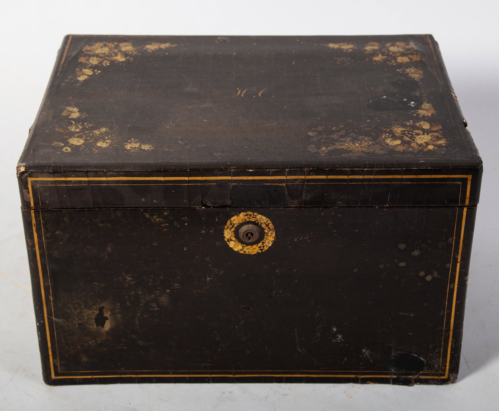 LAQUERWARE TEA CADDY: Black lacquered outer case with floral and line decoration. Interior is zinc lined with engraved Asian garden design. Wear. Crazing and case damage and chips and loss. H-8" L-13" F-G