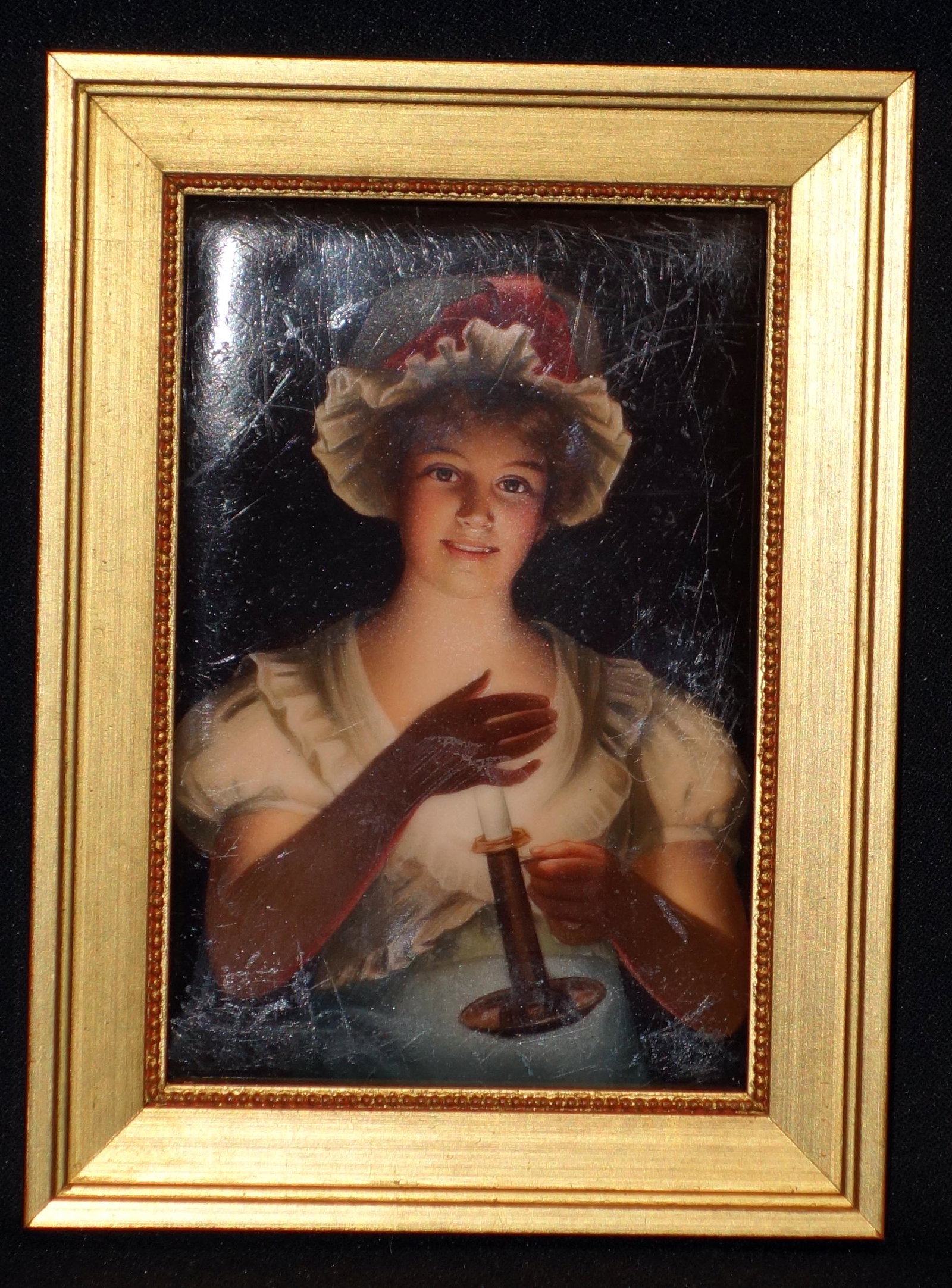 PAINTING ON PORCELAIN: Young woman with chamber stick. Numerous surface scratches and wear. 5/5" x4". F