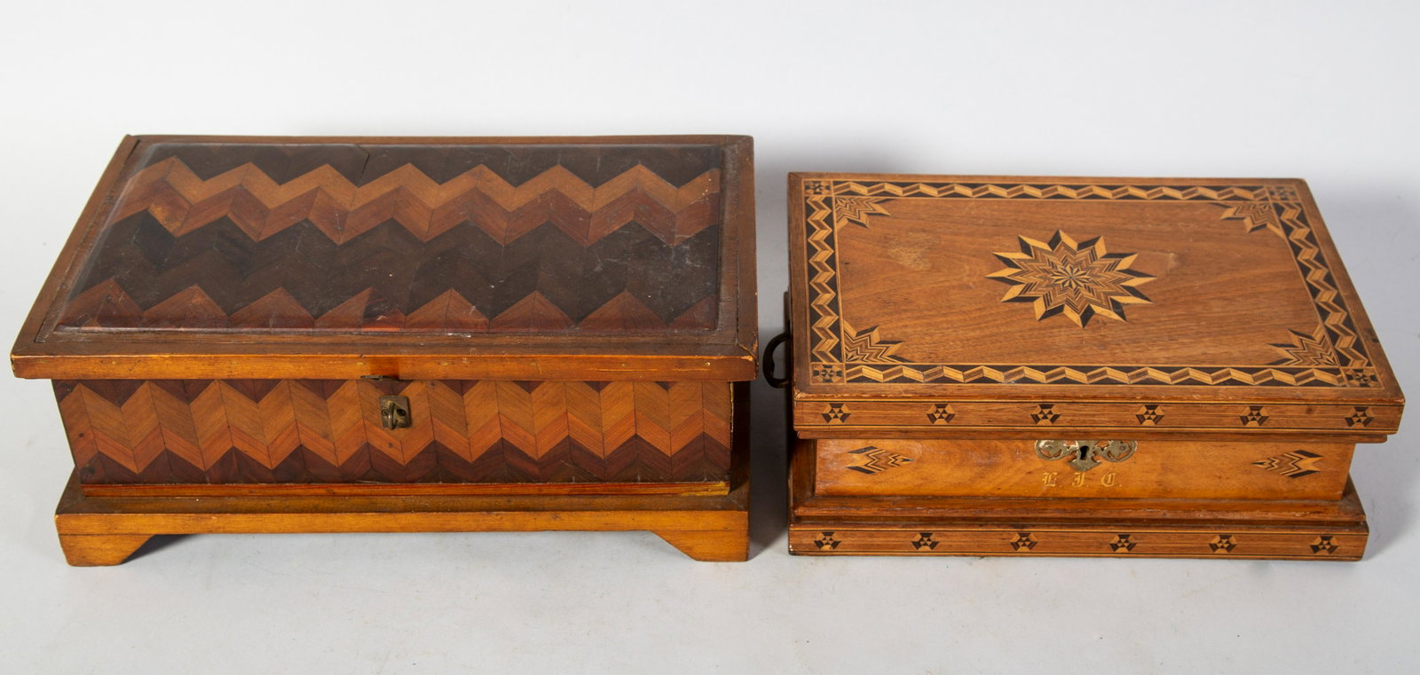 INLAID JEWELRY BOXES (2): wood with geometric inlays. Largest Box fitted with tray-fabric well worn. Smallest box has mirror in lid. Normal wear. Largest H6" L14" G-VG