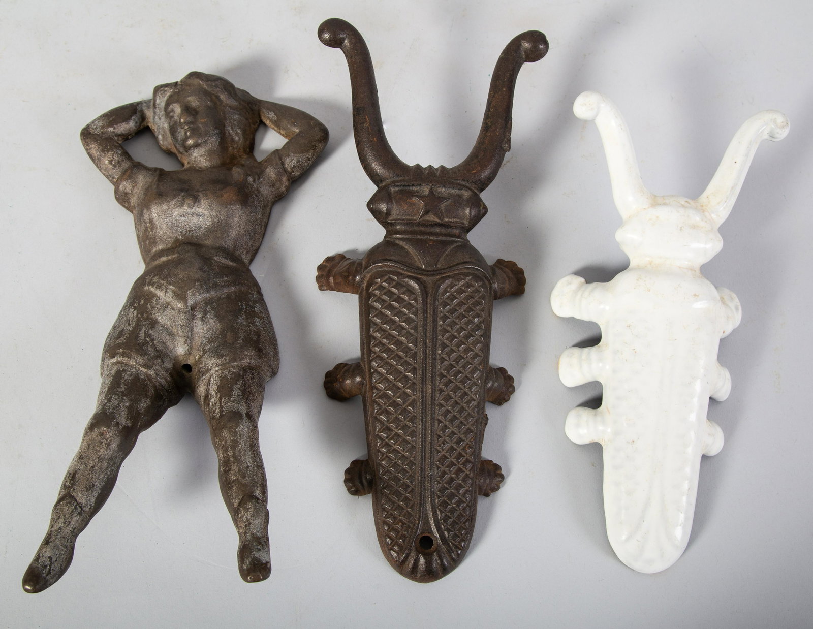 FIGURAL BOOT JACKS (3): Cast iron. (1) Naughty Nellie (1) Beetle-White Porcelain (1) Beetle-star L11" Normal wear. G-VG