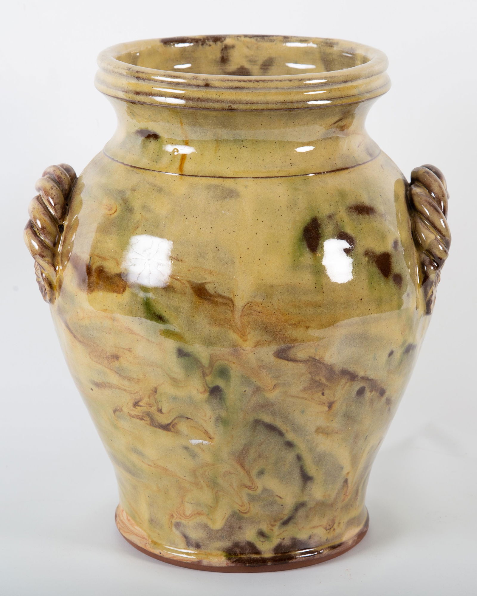 GLAZED REDWARE CROCK: Green and brown glaze; rop twist handles; looks contemporary; slight crazing; H- 11 1/2"; G-VG