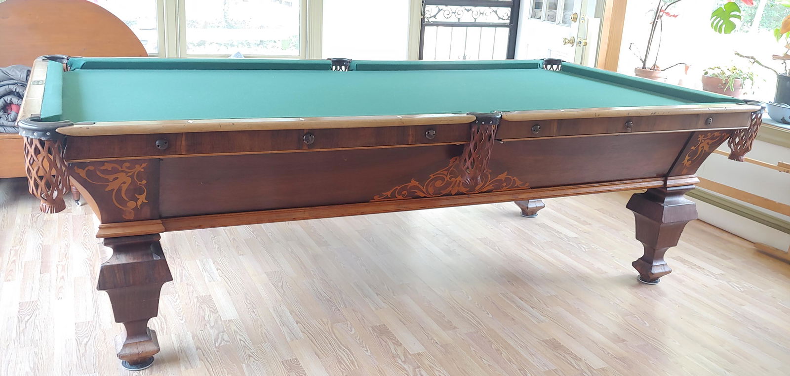 BRUNSWICK VICTORIAN POOL TABLE: Rosewood and inlay; rails appear faded; some small areas of veneer damage; G-G+ This table will remain at the consignor's residence. Purchaser must remove table from that location (21228). If a previe