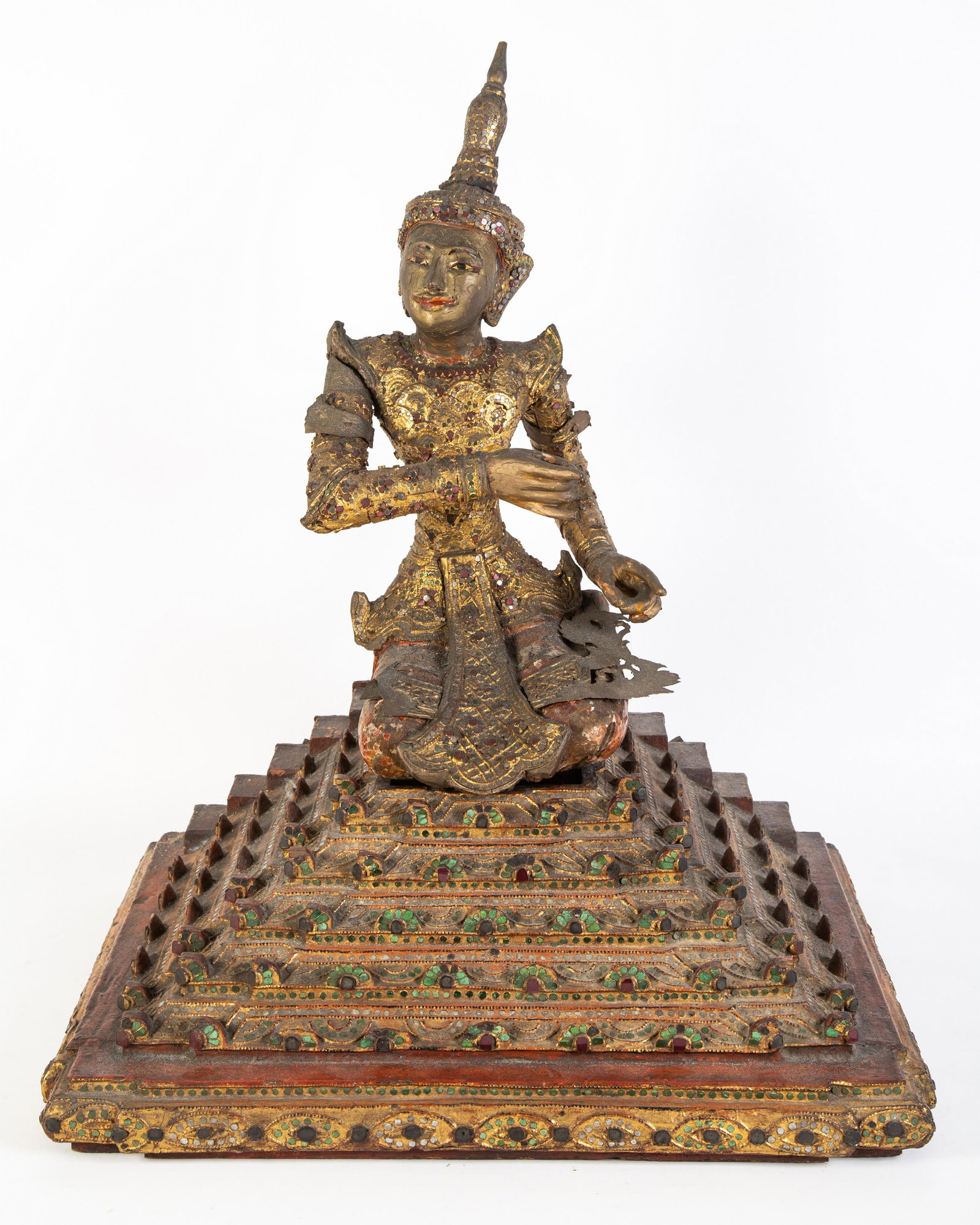 THAI BUDDHIST DEVOTEE: First half 20th Century; carved, gilt and painted wood with jewels and mirror decoration; rests on base; normal wear; H-24", G-VG