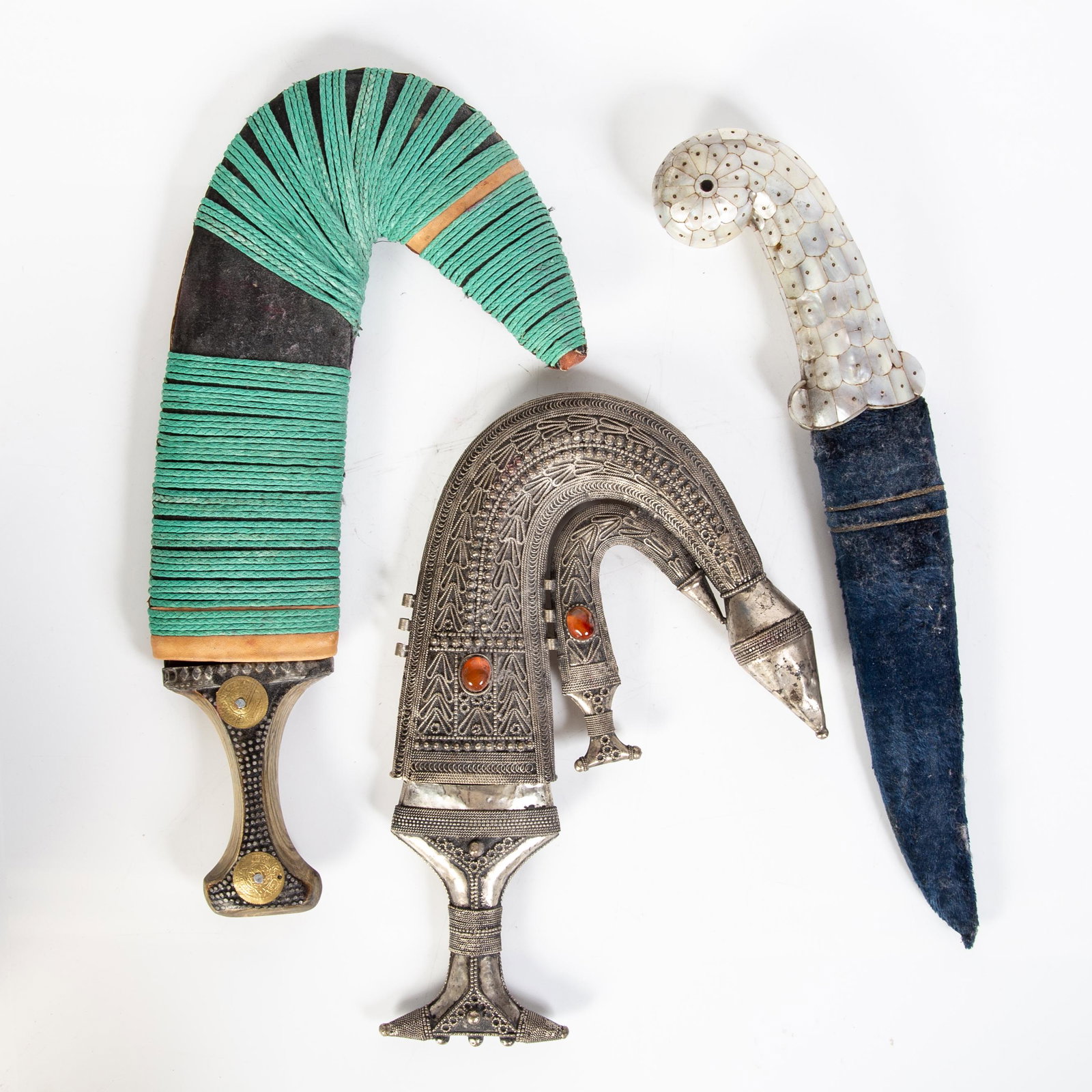 MIDDLE EASTERN DAGGERS (3): Modern; mother of pearl, wood, tin handles; normal wear; L-16", G-G+