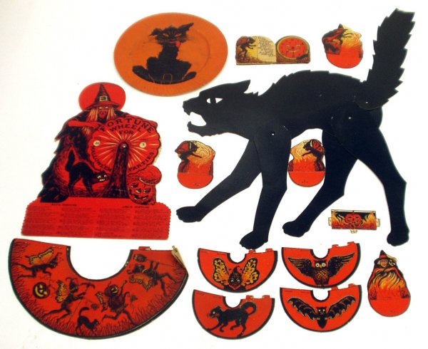 (19) DIECUT HALLOWEEN DECORATIONS: (19) DIECUT HALLOWEEN DECORATIONS - Cardboard litho, fortune wheel, cat hanger, cat plate, invitations, shades, decorations; some creases, tip of tail missing on cat hanger, edge roughness, blemishes 