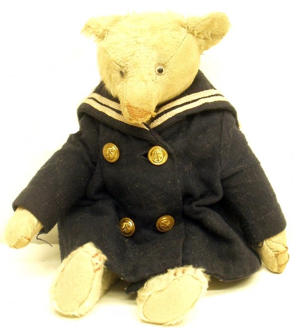MOHAIR BEAR: MOHAIR BEAR - In US Navy jacket; jointed; glass eyes; pointed snout; straw stuffed; wear to head and face; H-12", F
