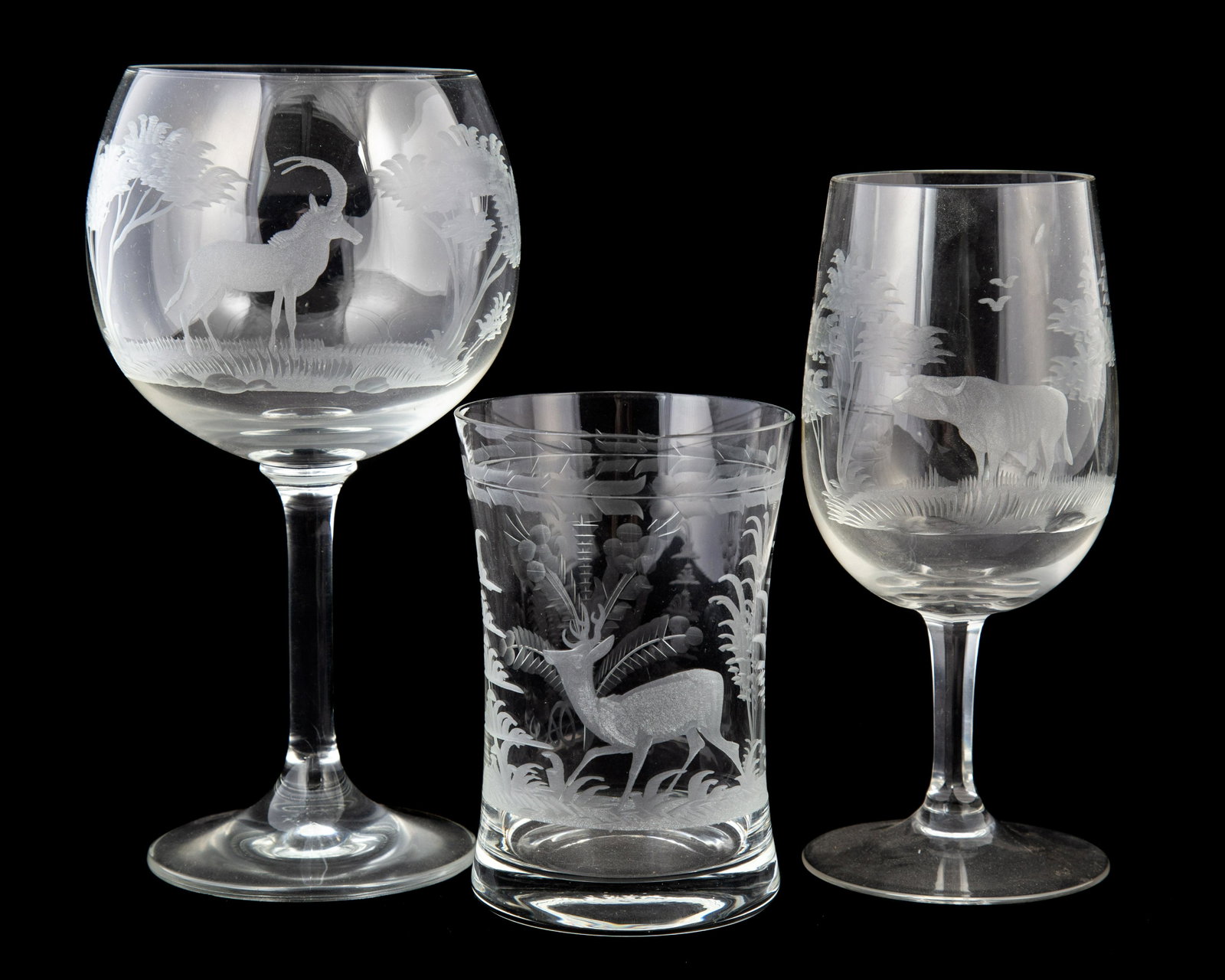ETCHED STEMWARE / CRYSTAL (68): Selection of African game etched crystal, includes: (12) old fashioned, (12) red wine, (16) white wine, (3) beer mugs; assorted odd pieces, together with (32+/-) Von Ponce etched crystal and decanters