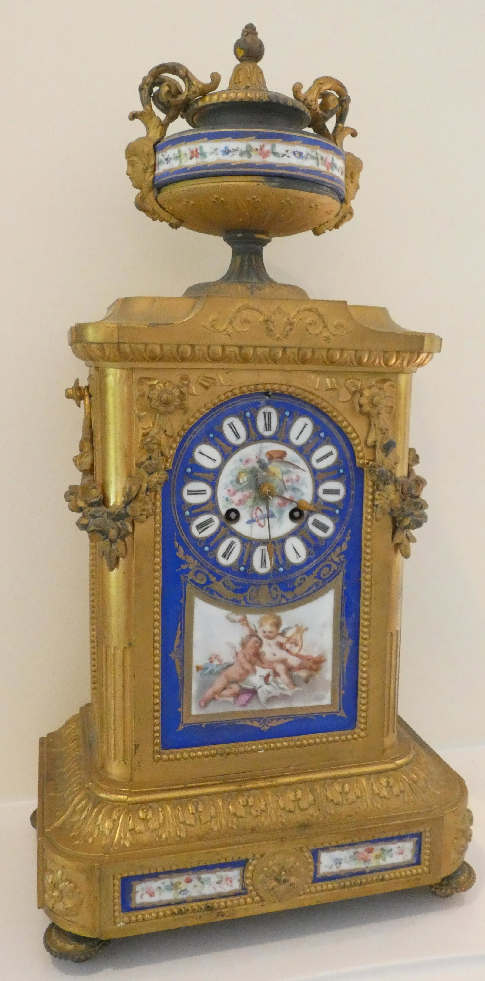 FRENCH MANTLE CLOCK: Urn top; bronze ormulu mounted; serves plaques in base and face; untested; normal wear; H- 21" W- 9"; G-VG