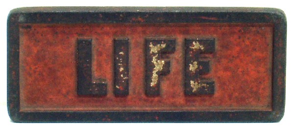 "LIFE" MAGAZINE WEIGHT: Embossed cast iron; weight for news stand papers; normal wear; L-6 1/2", G-VG