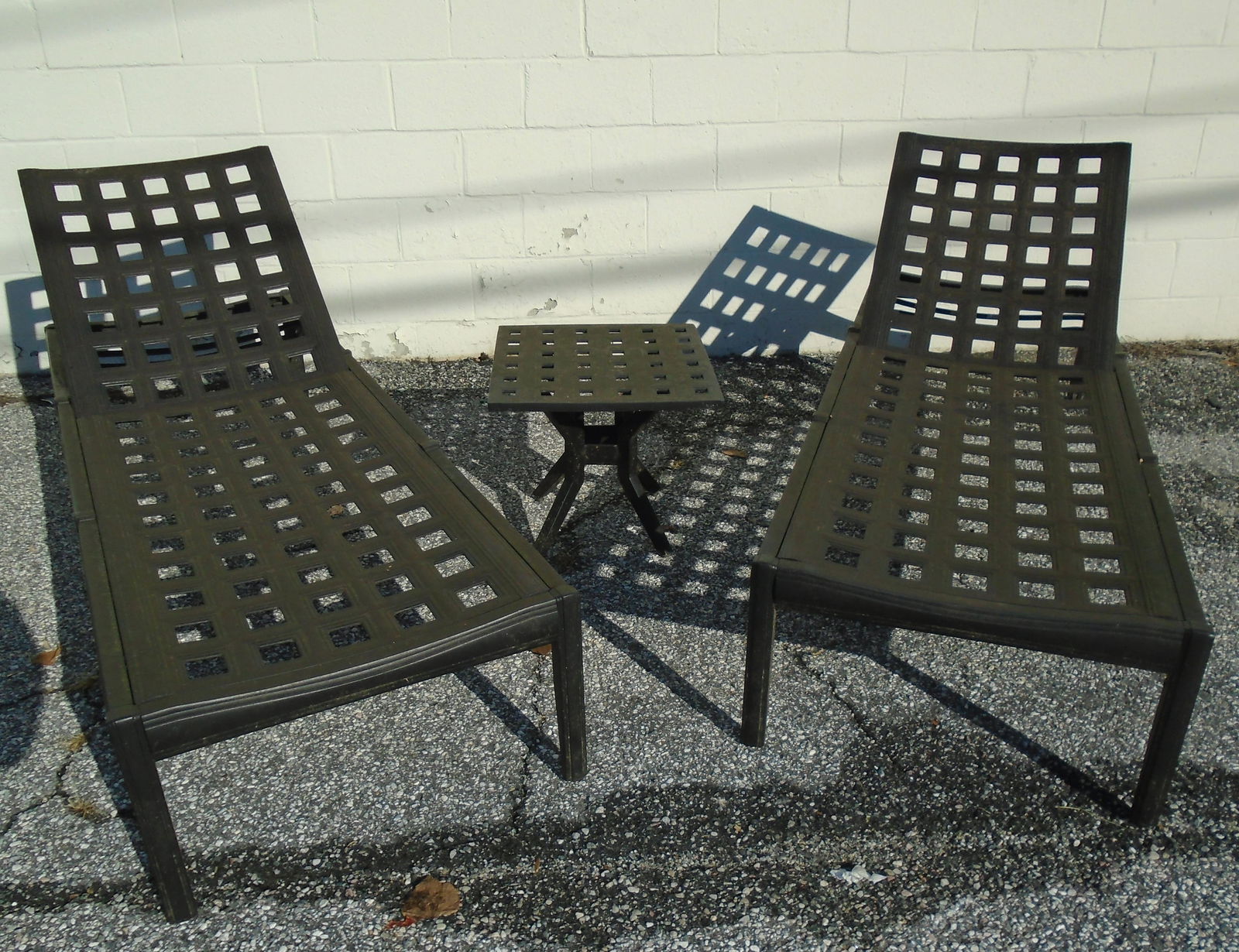 PATIO CHAISES and SIDE TABLE (5) PCS.: (4) heavy cast metal elevating chaise lounges together with (1) small matching side table; weathered; chaise 78" x 28", table 19" x 17", G