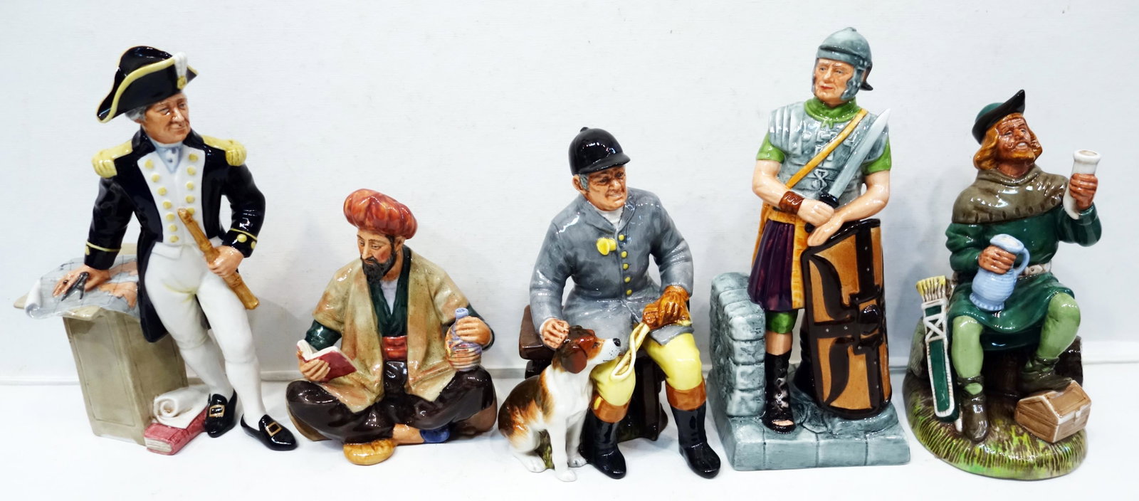 ROYAL DOULTON FIGURINES (5): The Huntsman HN2492- 1973; Omar Khayyam HN2247-1964, Robin Hood HN2773- 1984; The Captain HN2260- 1964; The Centurion HN2726- 1981, signed 6/18/83; 7"-10"