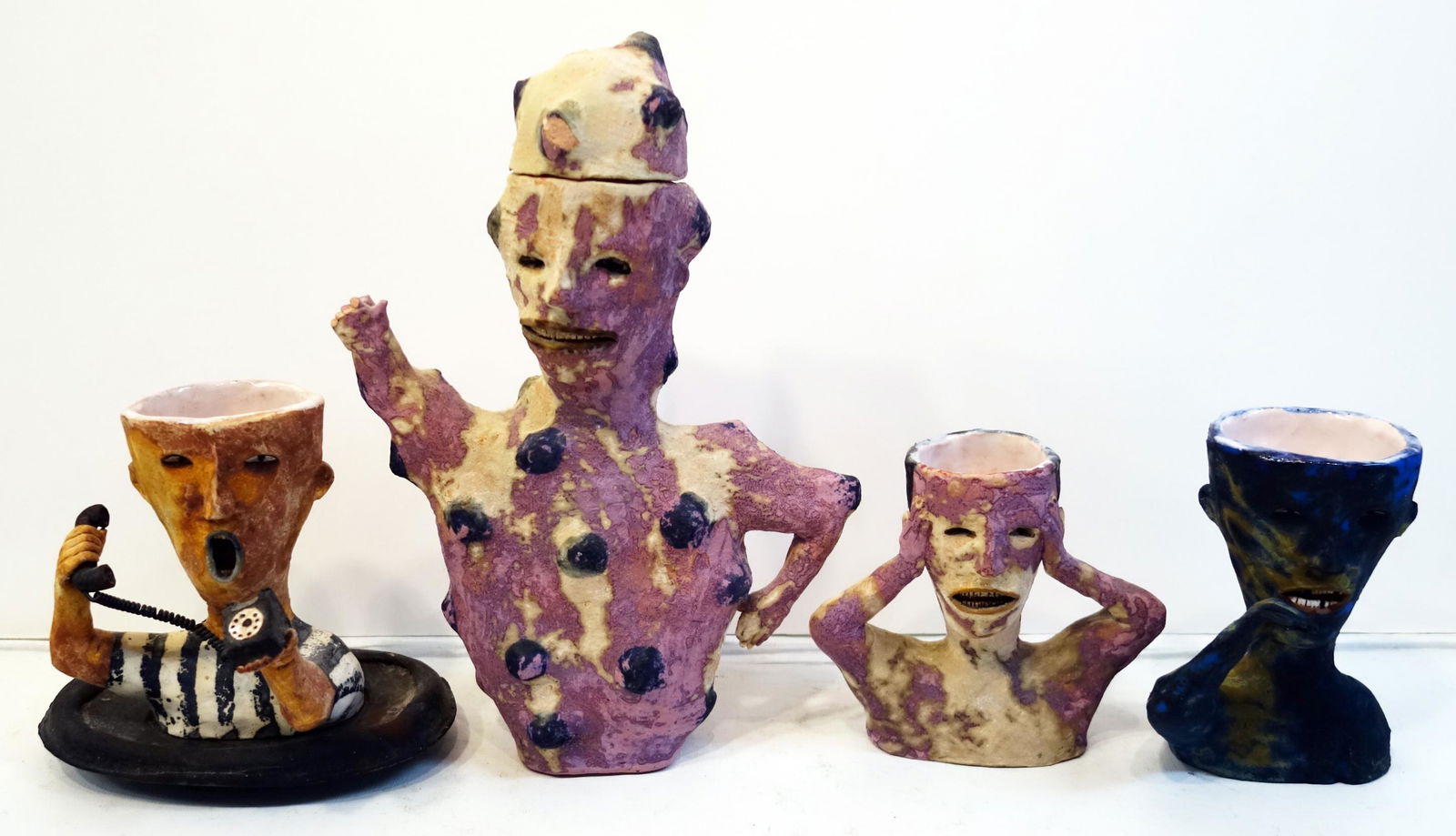 WESLEY ANDEREGG CERAMIC VESSELS (4): Includes: (1) man picking teeth, signed 1996, glazed interior; (1) man with hands on head, signed 1994, glazed interior; (1) man shouting on telephone, separate base, signed 1996, glazed interior; (1)