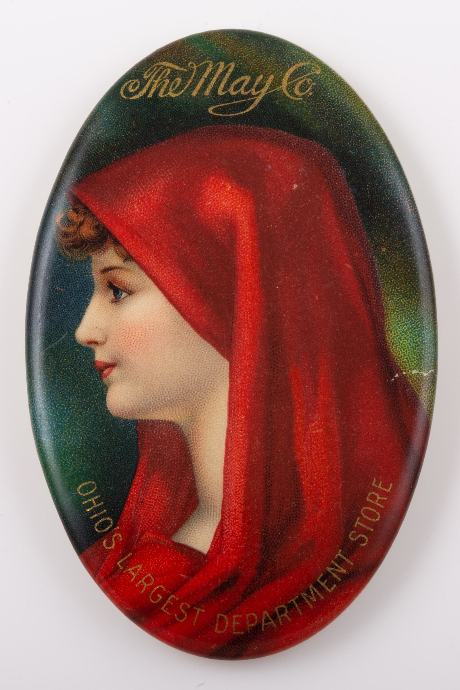 THE "MAY" CO POCKET MIRROR: Oval; "The May Co - Ohio's Largest Department Store", mirror has some spots; minor scratches; normal wear; H-2 3/4", VG