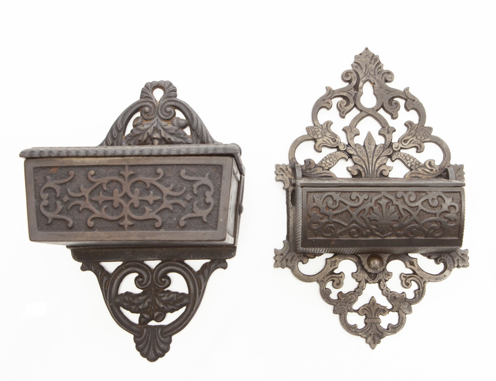CAST IRON MATCH POCKETS (2) PIECES: Wall mount; hinged covers; geometric pattern; original finish; normal wear; H- 6"; G-VG