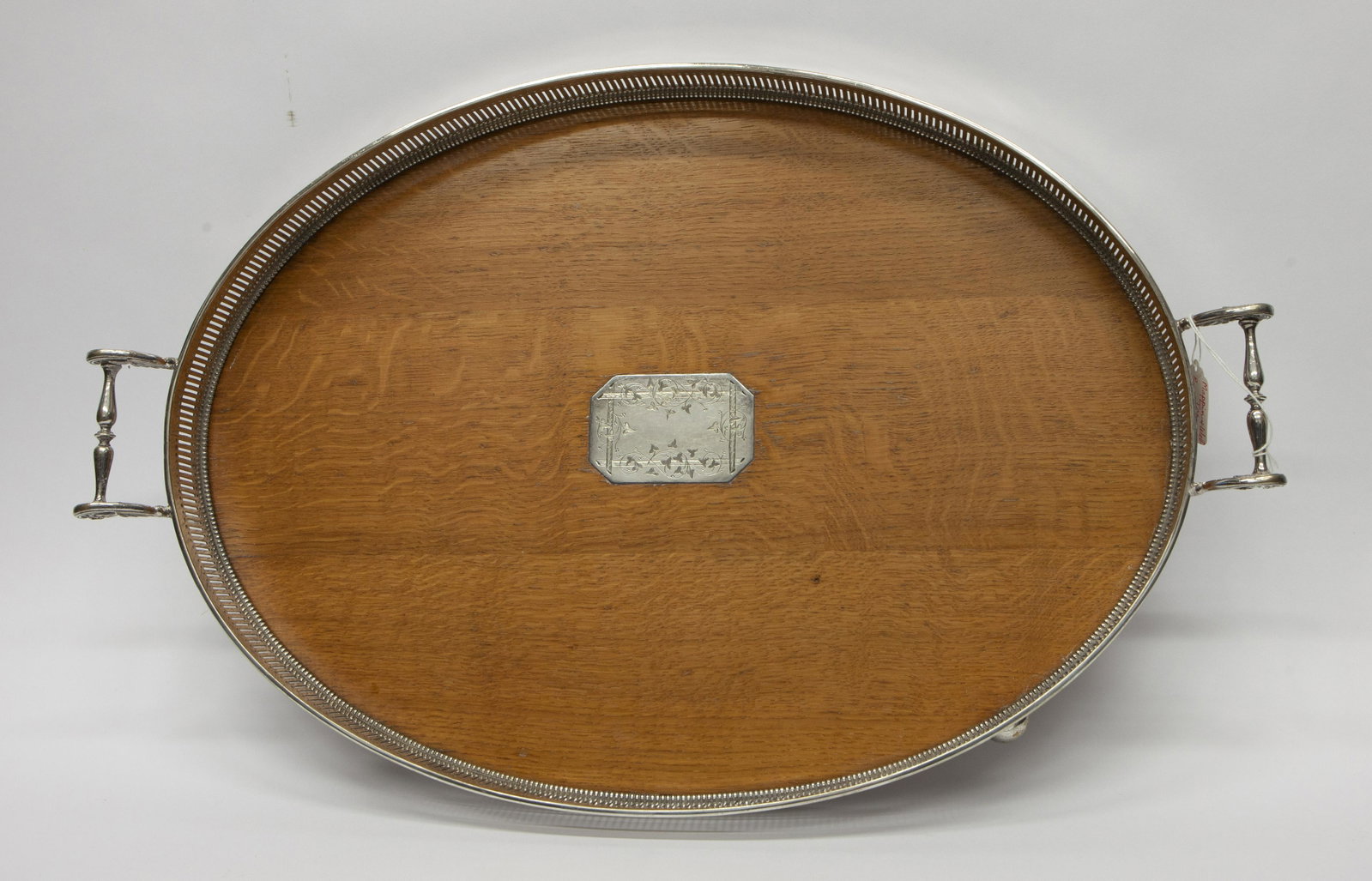MAPPIN AND WEBB SERVING TRAY: Large oval oak tray with plated silver gallery, handles and ball feet; central inset plaque but not monogrammed; normal wear; L- 25"; G-VG