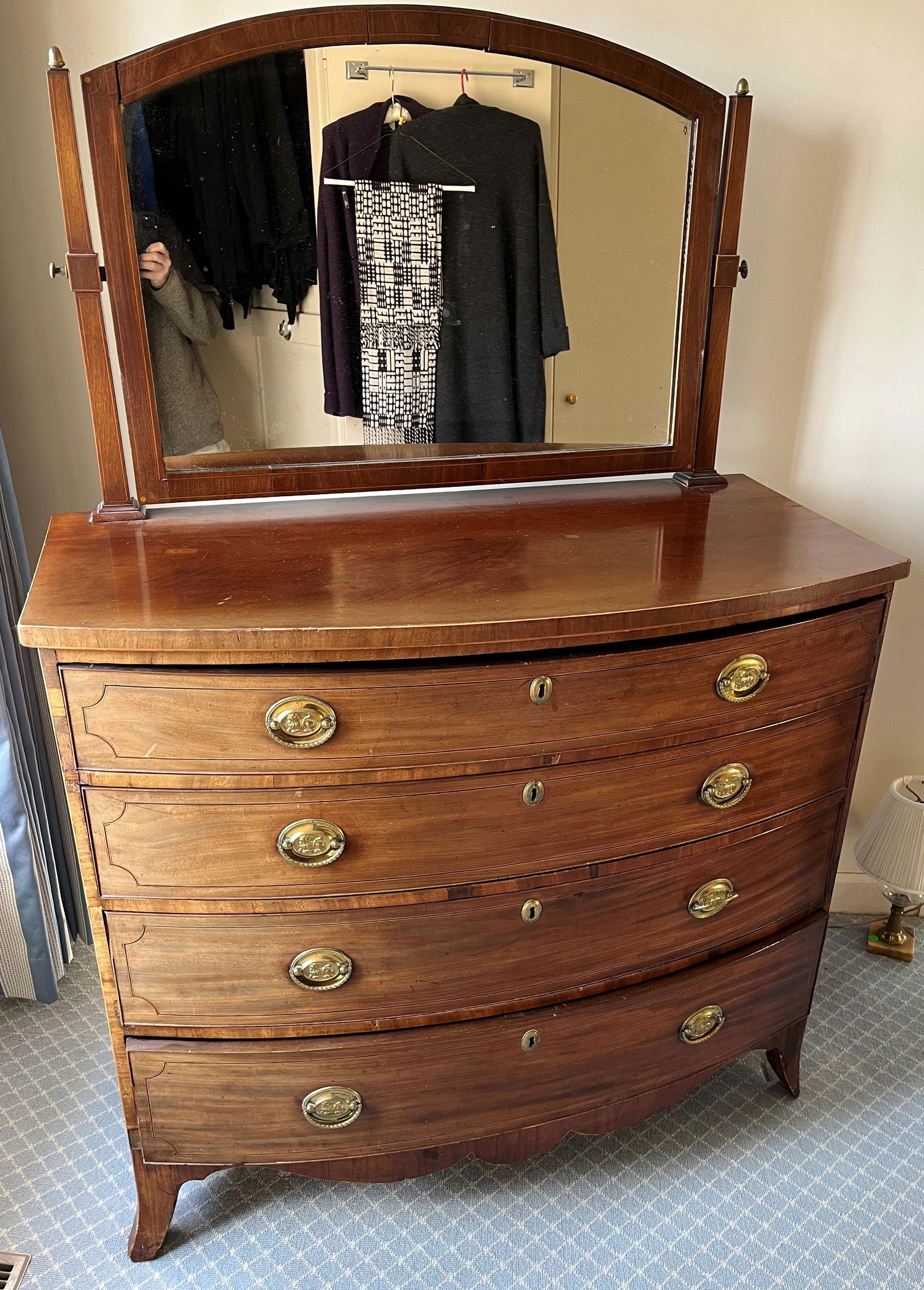 HEPPLEWHITE CHEST DRAWERS: Mahogany; bowfront; four drawers; mirror-later addition; piece to foot needs gluing; two dutchmen in top; top slotted to insert mirror; sun faded; drawer trim missing; chest H- 39"; W-45"; F