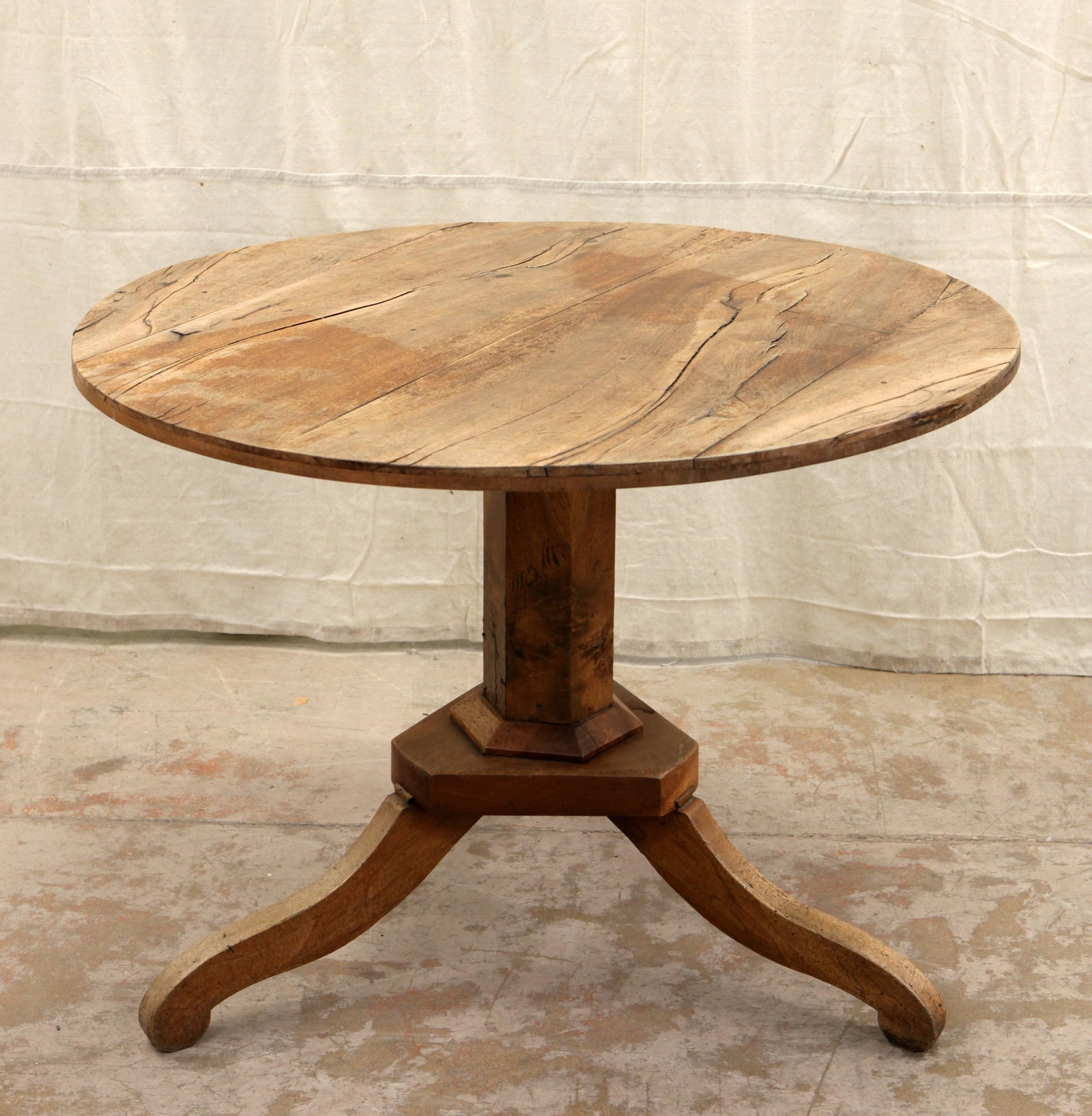 BIEDERMEIER TYPE CENTER TABLE: Antique; partial Circassian walnut; fixed pedestal base; top checked; finish worn; H- 28" x Dia.- 38"; F-G