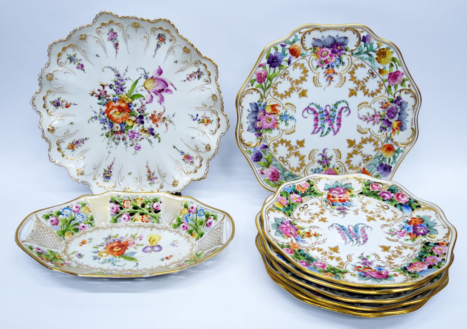 (9) DRESDEN ETC. PORCELAIN TABLEWARE: Transfer & hand painted w/ gilt decoration; includes: (1) reticulated bread dish- marked R.W. Bavaria on bottom; (1) charger w/ scalloped rim; set of (7) matching reticulated plates & charger; minimal