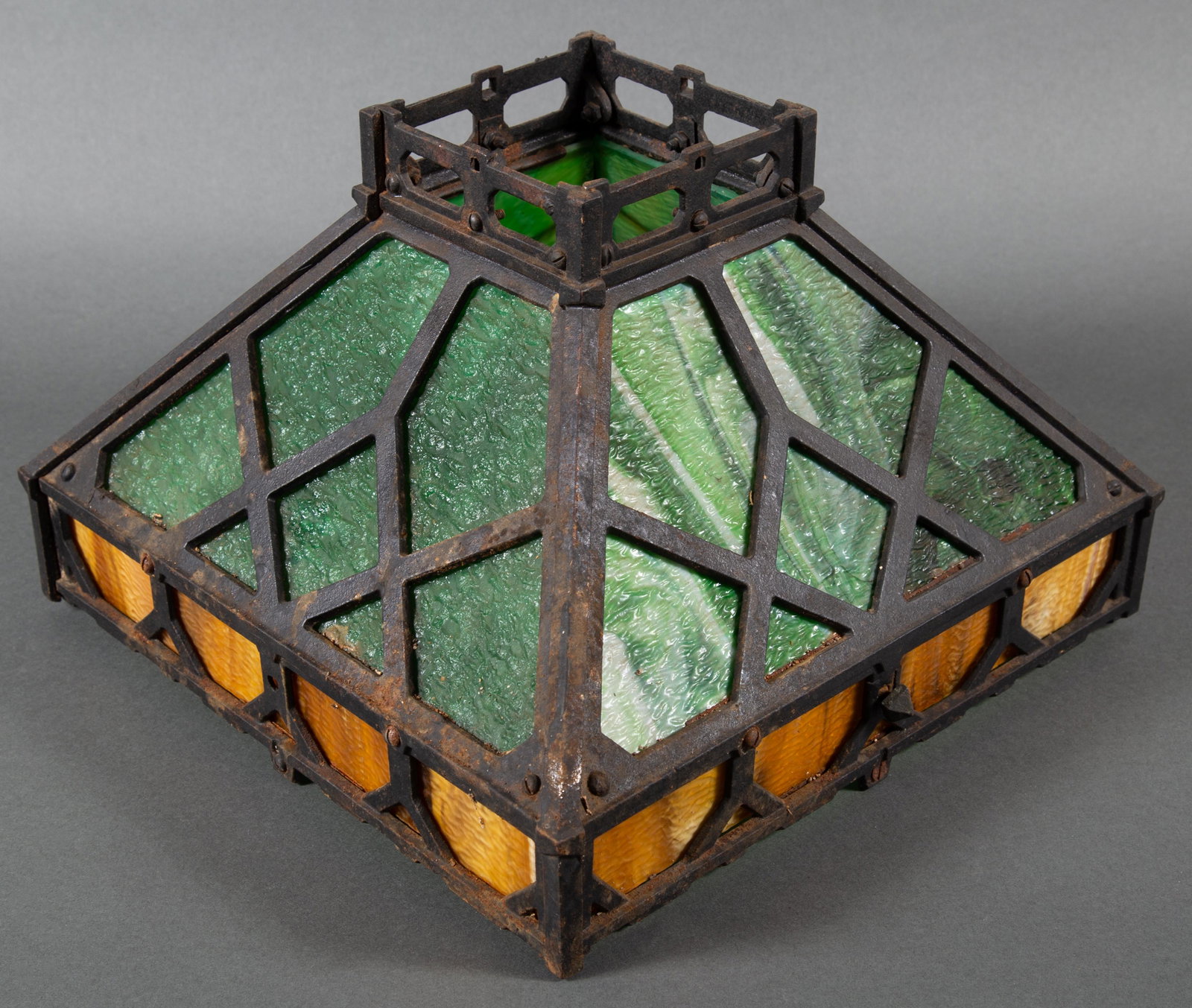 Cast Iron Mission Arts & Crafts Lamp Shade with Slag Glass Panels: Circa 1910 - 1915 Cast Iron Lamp Shade which we attribute to Bradley & Hubbard though it is unmarked. 14" square and 9 1/2" high. Mustard umber lower panels with pine green upper panels. CONDITION: Go