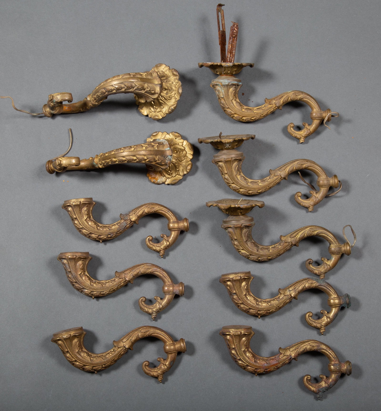 10 Cast Bronze Fanciful Chandelier or Sconce Arms: 10 Cast Bronze Arms in sufficient quantity to construct a chandelier and matching sconces. Each measures approximately 7" long. Thread size of 1/8" IP implies that these are American though possibly C