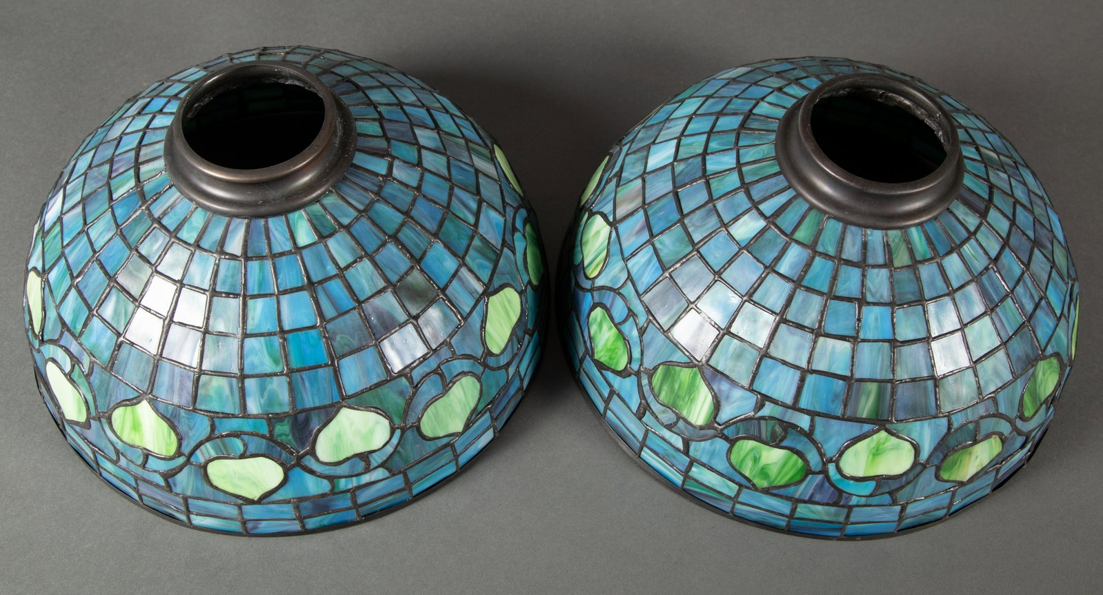 Pair Manner of Tiffany Blue & Green Acorn Pattern Leaded Glass Shades.: A matched pair of leaded glass shades in the manner of Tiffany. These are not of the period and date to the 1990's. Each measures 12" in diameter and 6 1/2" deep with a 2 3/4" diameter opening at uppe
