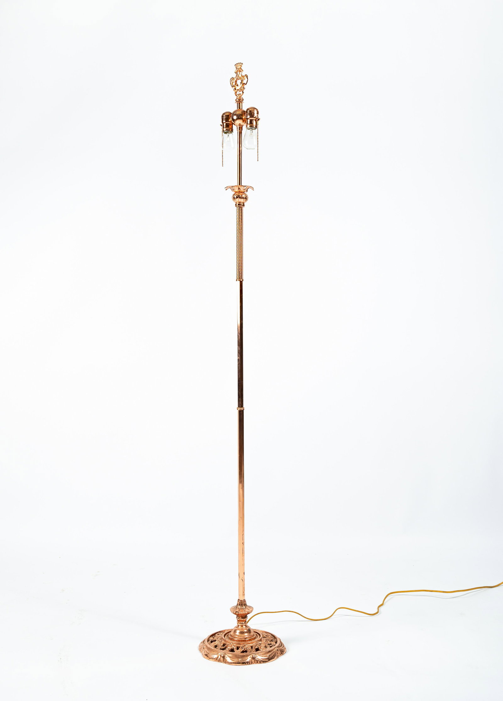 Ornate Polished Copper Floor Lamp Circa 1920: Professionally and completely restored antique floor lamp of simple yet fanciful design. Relatively recently polished and lacquered with all new cloth wiring and Bakelite plug. Note dual socket cluste