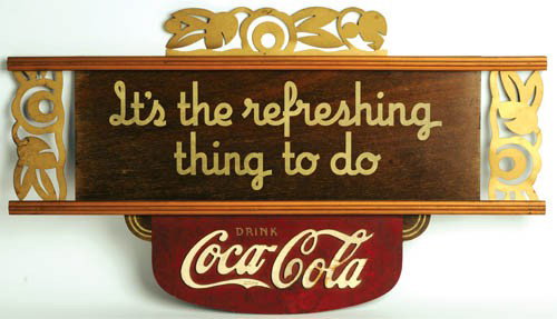 1930'S COCA-COLA KAY DISPLAYS SIGN: 1930's Kay Displays wood cutout with metal trim hanging sign 17"x 29". Some flaking on white logo, tarnishing on gold tin cutout. Small (wood) tail missing on last "A" in logo. A beautiful sign