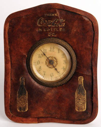 EARLY 1900'S COCA-COLA LEATHER DESK CLOCK: Early 1900's leather desk clock gold stamped with two bottles "In Bottles". Some cracking. Leather edge has been recreated to reinforce edges. Wear on gold stamping