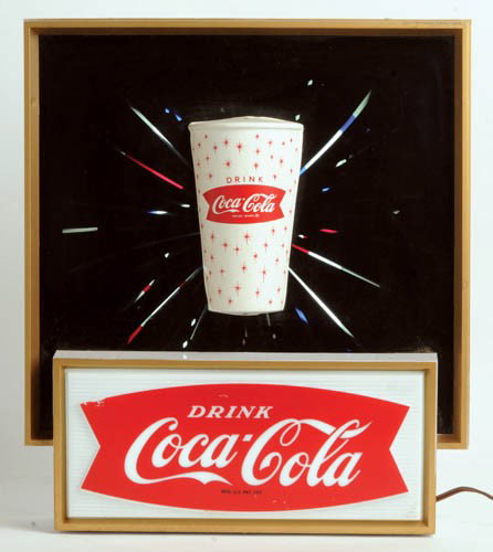 1960's Coca-Cola lightup sign "Starburst": 1960's lightup sign "Starburst" Plastic front, tin can, works perfect. Very dramatic motion of shooting stars from cup. There are three versions of this sign. This one is the paper cup. Some scratches