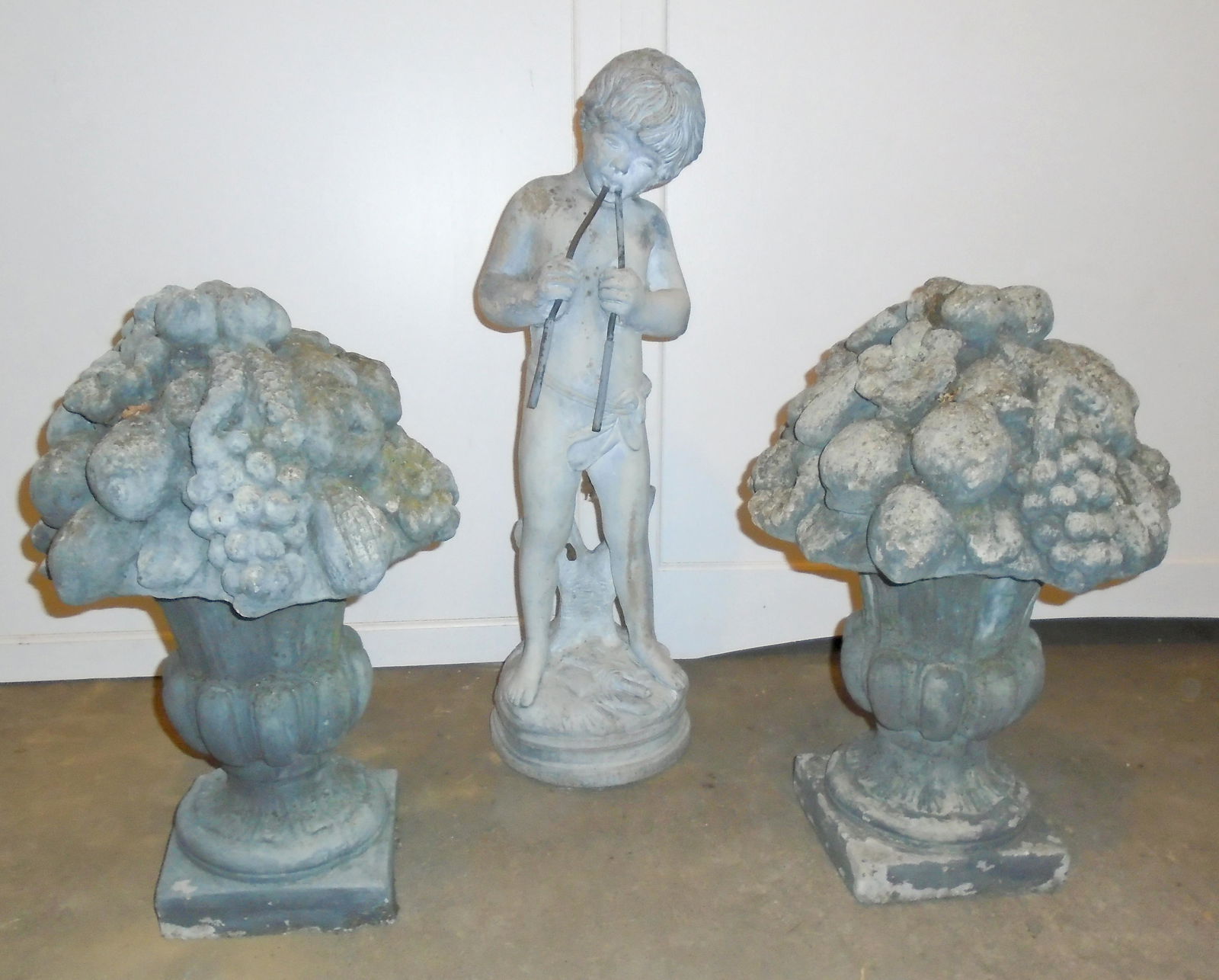 (3) CONCRETE GARDEN PIECES: (1) statue of a boy; fountain topper; H- 30"; (2) urns with fruit décor; H- 22"; paint is fading and chipping; chips and wear on urns; F-G