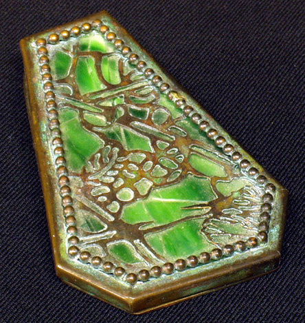 RIVIERE STUDIOS Bronze and Slag Glass Paper Clip: Grapevine pattern with green slag glass; damage to glass; impressed mark; 4 ¼" (length)