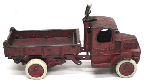 ARCADE MACK DUMP TRUCK: Cast iron, painted red, rubber tires, repainted; scratches all over; some rust mostly in bed; L-12", G