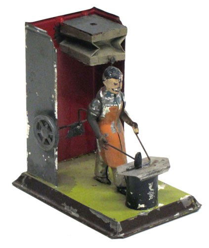 BLACKSMITH STEAM ATTACHMENT: Possibly Carette #108/00; blacksmith with bellows; painted tin, wood and paper; paint flaking; some loss; H-5 1/4", base 5 1/4" x 3 1/2", G-VG