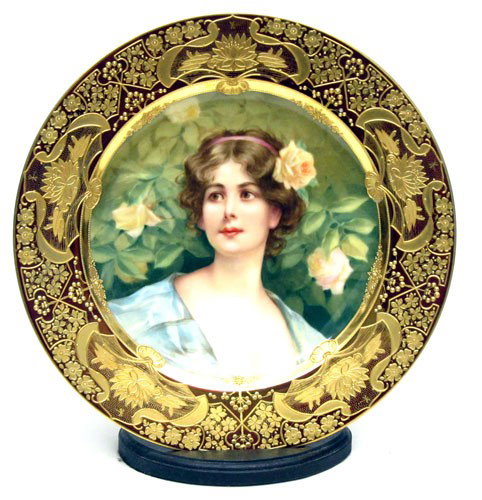 ROYAL VIENNA PORTRAIT PLATE: Well executed portrait with bold gilt water lily and foliate border, "Blukende Rosen" beehive mark; Dia.-9 1/2", EX