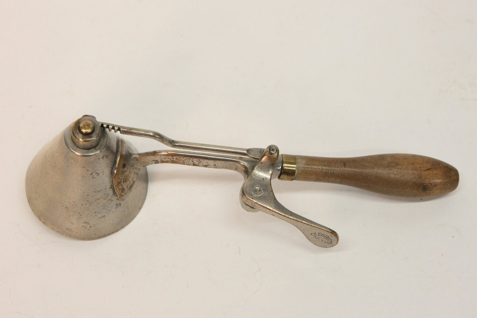 GILCHRIST ICE CREAM SCOOP: #33, cone shape, metal with wood handle, some pitting, brass showing, wear, L-10 3/4", G-G+