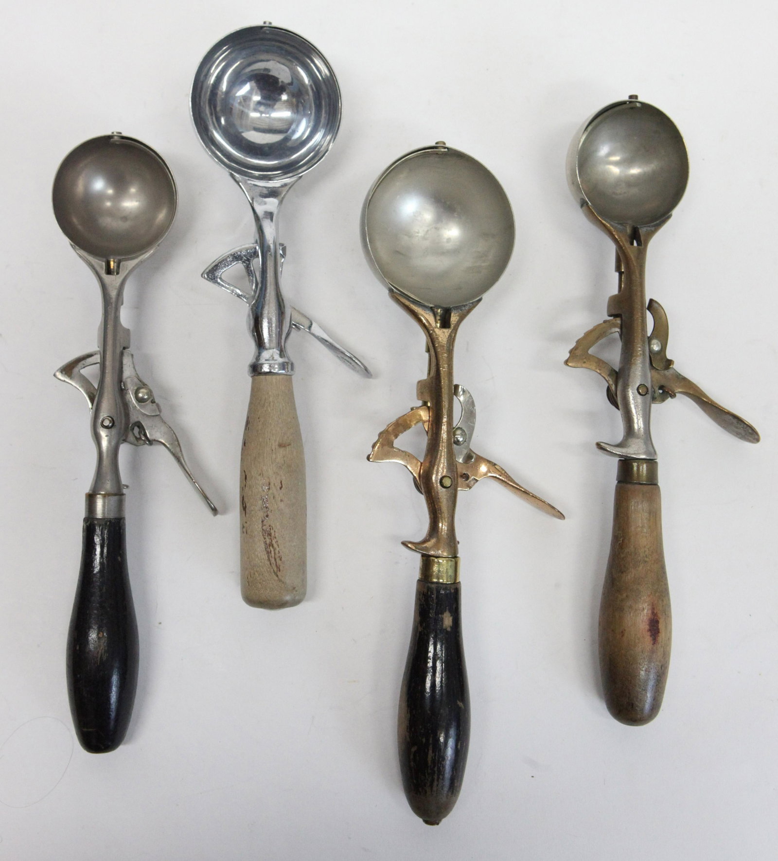 ICE CREAM SCOOPS (4): Metal with wood handles, (3) Clipper #4, 2-'20's, 1-10 sizes; (1) New Gem, wear, L-10 1/2" - 11 1/2", G-G+