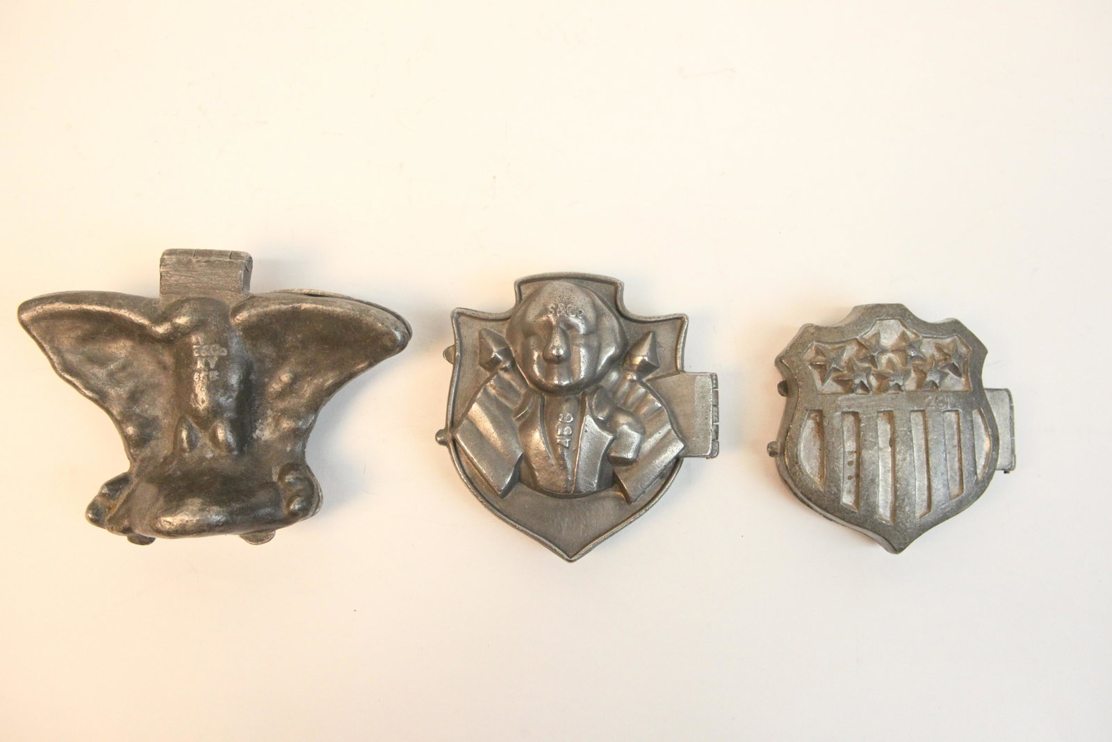 ICE CREAM MOLDS (3): (1) eagle, spread wings, E & Co. #655; (1) George Washington, S & Co, #456; (1) flag and shield, #281; normal wear; H-4 +/-", G-VG