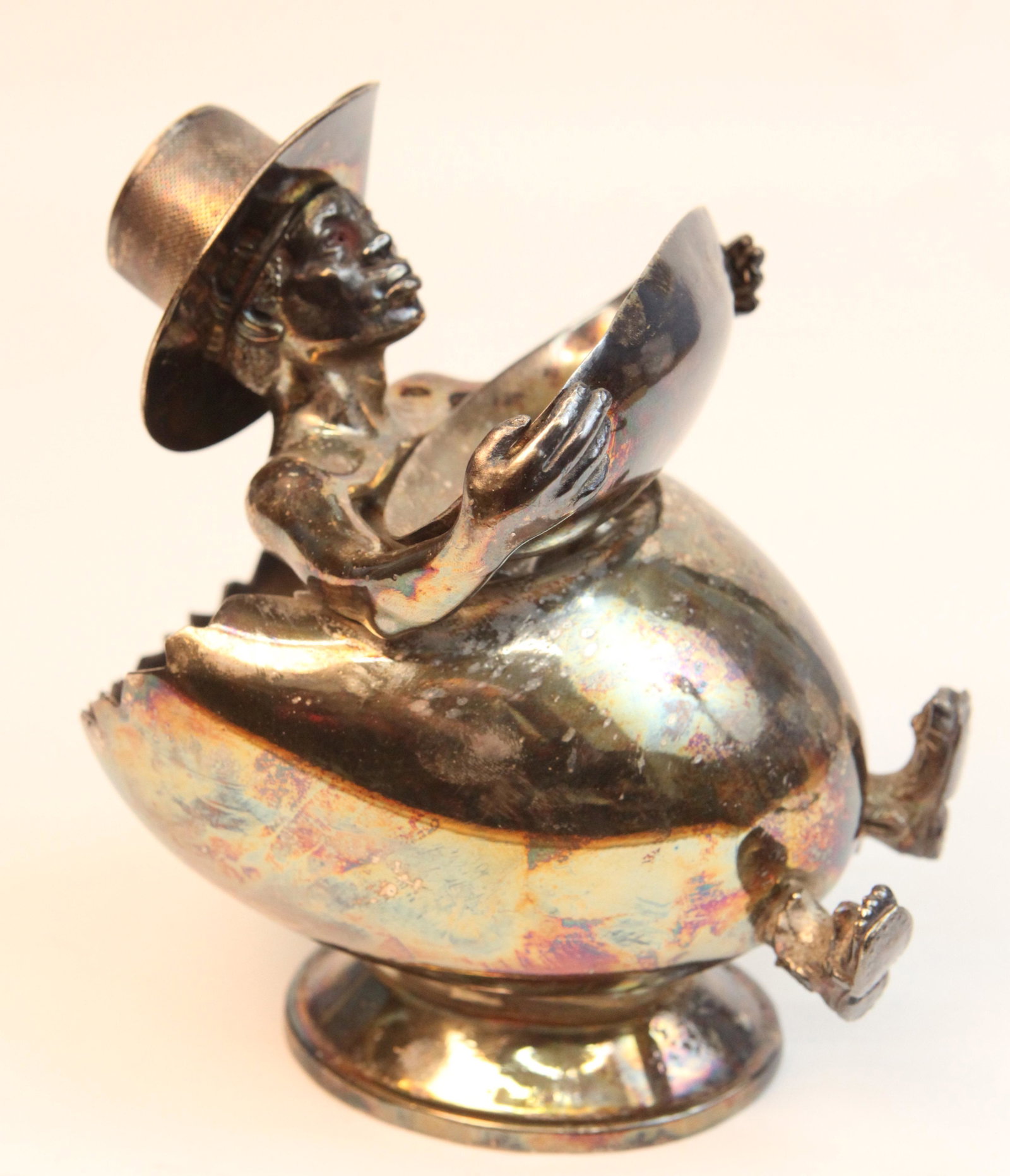FIGURAL TOBACCO JAR: Silverplated, black figure in egg shaped container with match holder / striker hat; "Wilcox", #1780, some dings and dents, some pitting; H-8", G