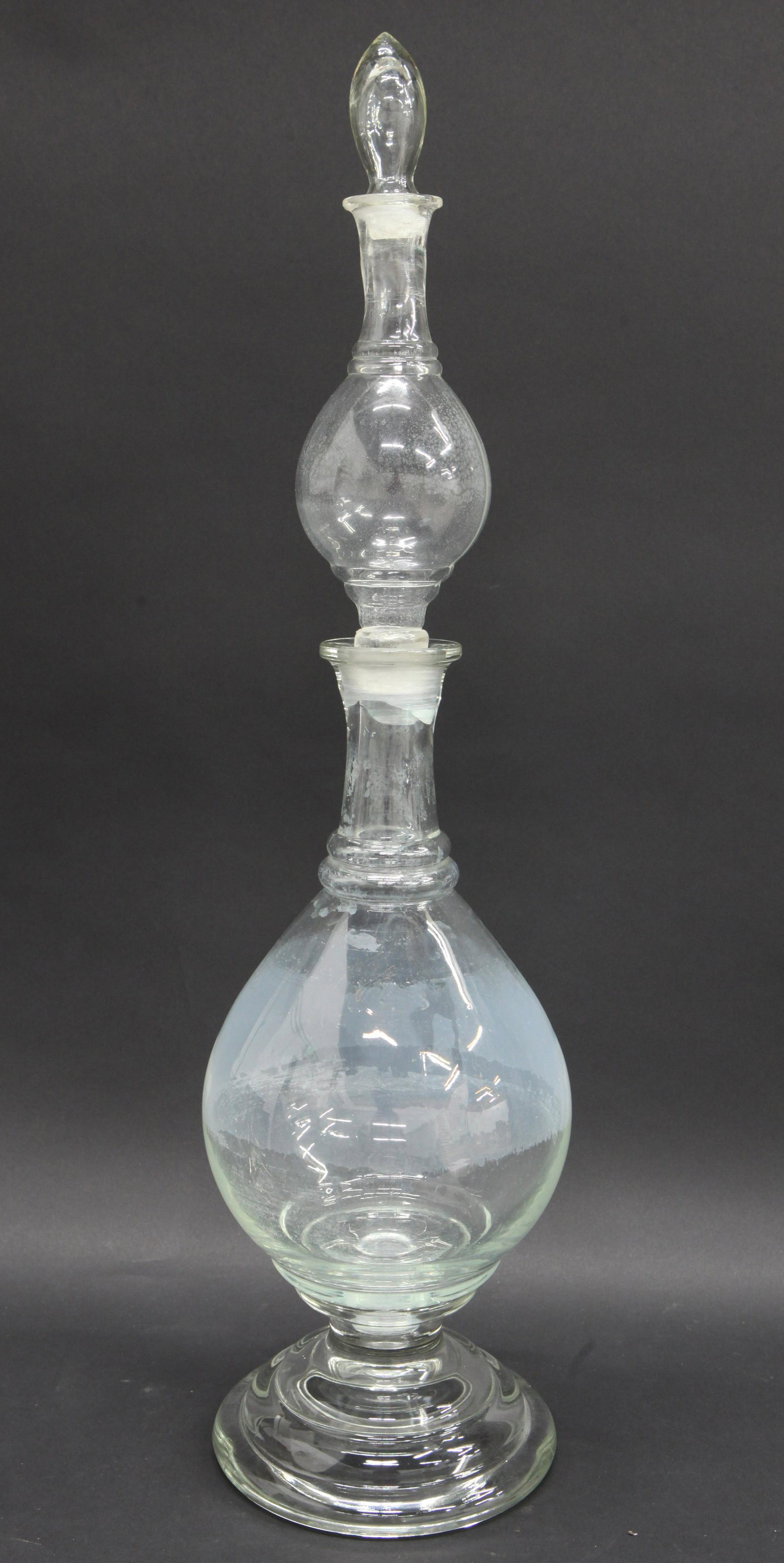 PHARMACY TIERED SHOW GLOBE: Clear glass, four piece, upper globe has lip crack; stopper bottoms have roughness, minor interior spotting, normal wear, H-26 1/2", G