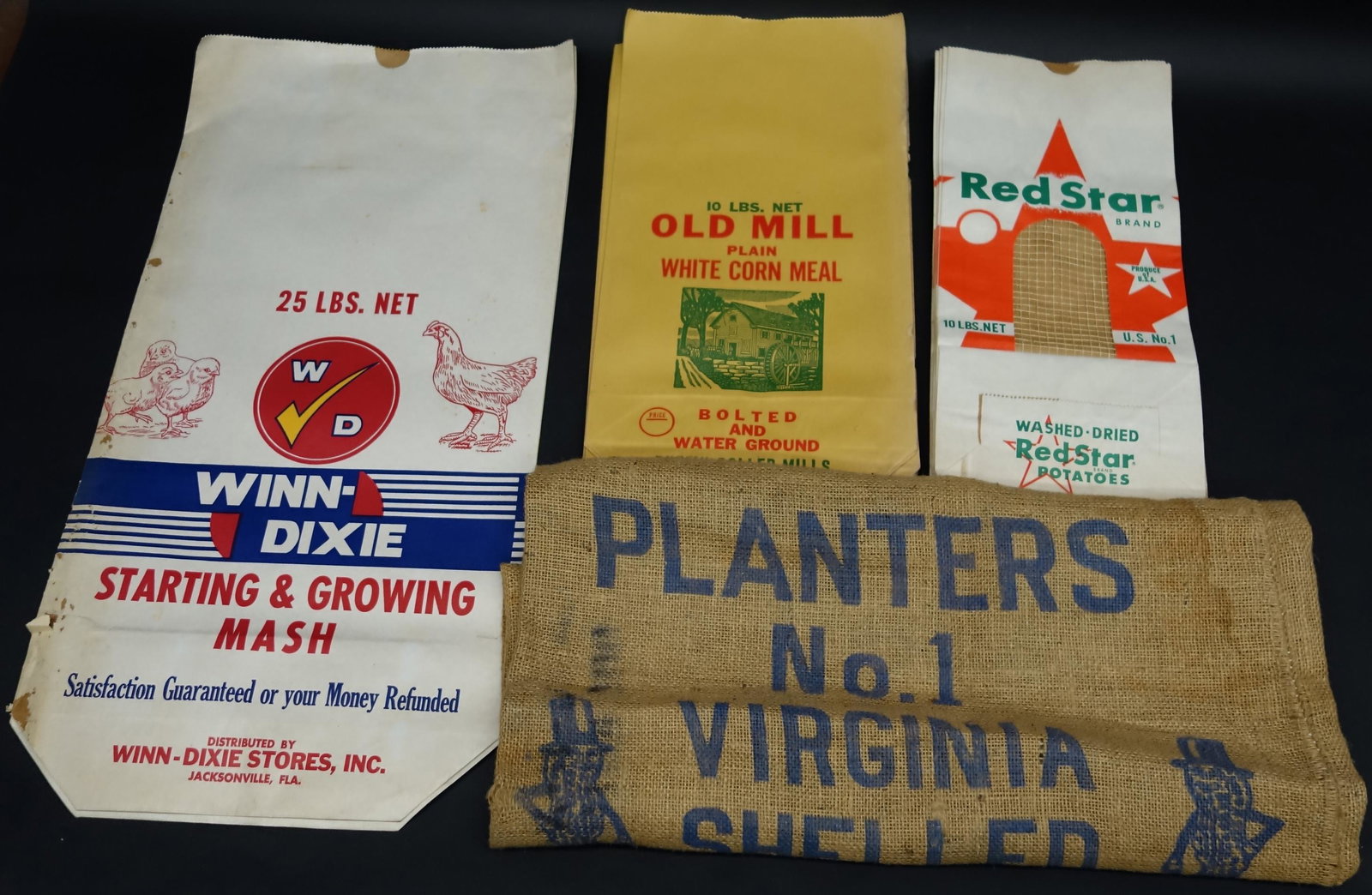GROCERY STORE BULK BAGS (23): Includes: Winn-Dixie Starting and Growing Mash, Old Mill Cornmeal, Red Star Potatoes, Planters Peanuts; paper and burlap, normal wear, largest 39", G-VG