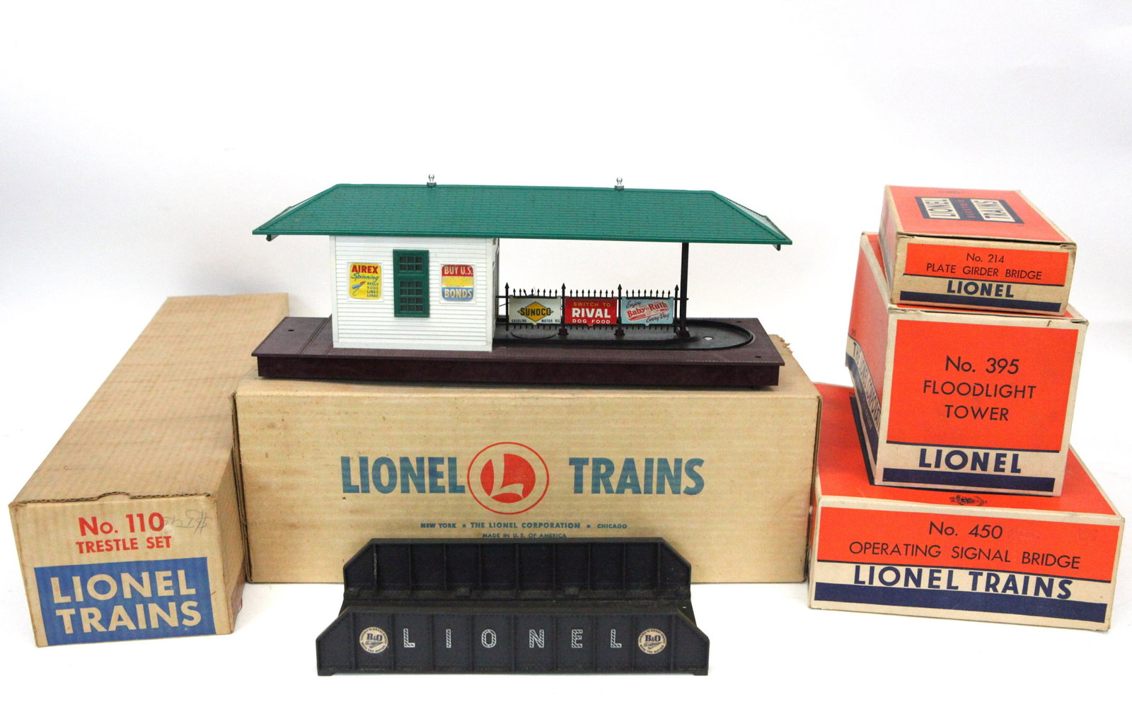 LIONEL ACCESSORIES (5): Original boxes: (1) freight station #356, (1) trestle set #110, (1) operating signal bridge #450, (1) floodlight tower #395, (1) plate girder bridge #214; normal wear; VG-EX