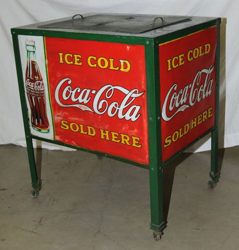 LATE 1920'S TO VERY EARLY 1930'S COCA-COLA COOLER: Metal frame with four embossed tin signs on each side; another cooler you seldom see; missing cap catcher; retains original lid; medium to heavy overall wear, especially to the signs with the bottles