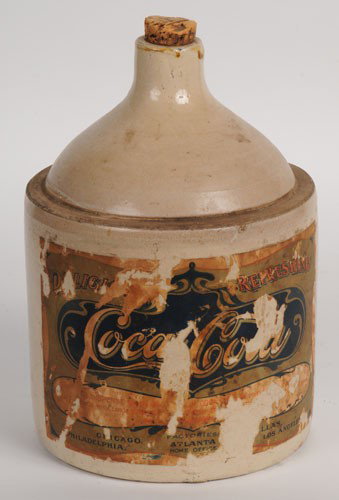 EARLY 1900'S COCA-COLA STONEWARE JUG: 11" tall; has a label on both side; roughly 70 to 75% of each label survives; still quite readable, back label addresses trademark protection and re-filling issues; jug itself is quite sound with no c